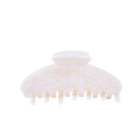 Large white swirl acetate hair claw clip with curved design and firm hold.