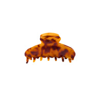 Medium tortoise acetate hair claw clip with classic pattern and secure grip.